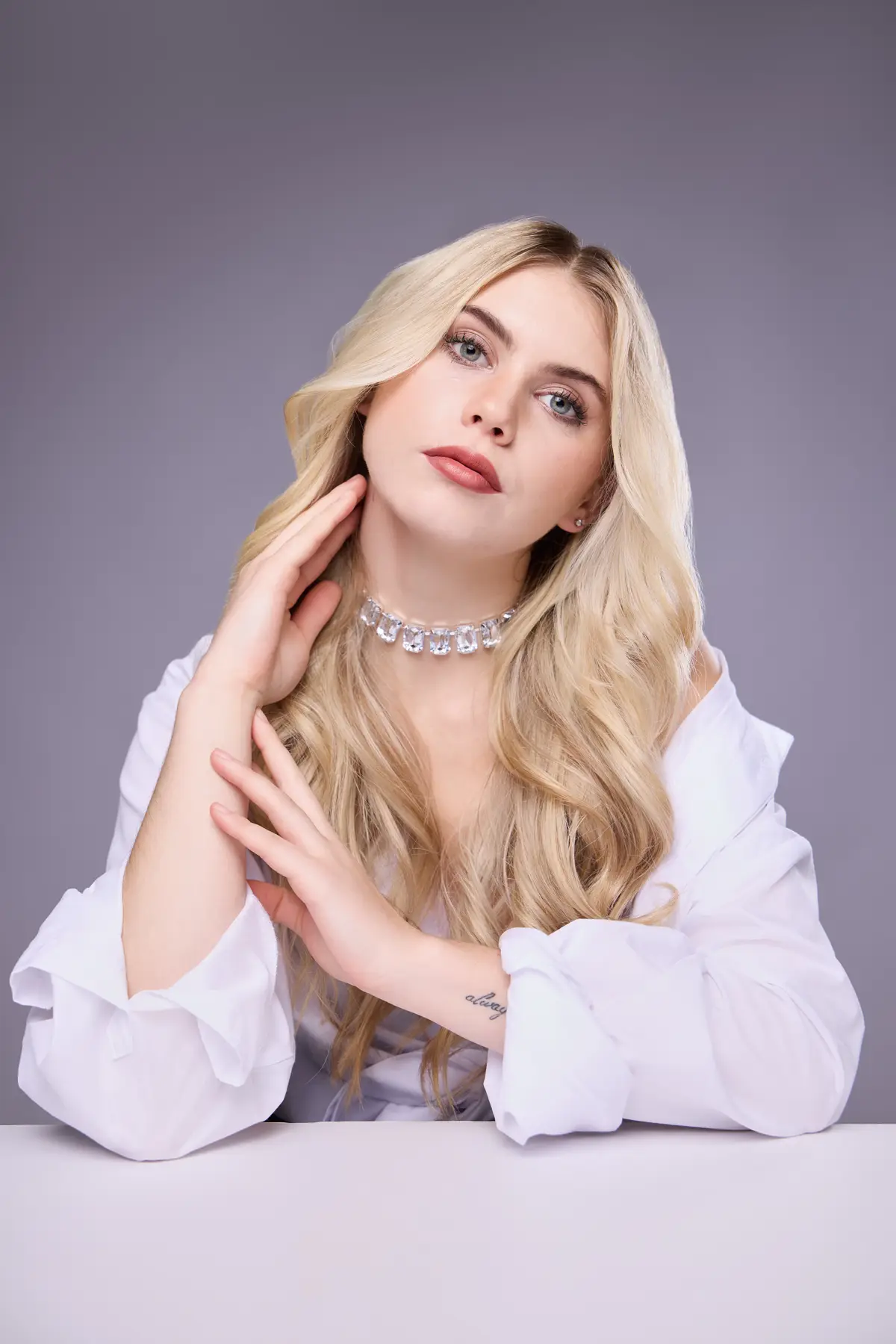 Beauty portrait with soft make-up and long styled blond hair.