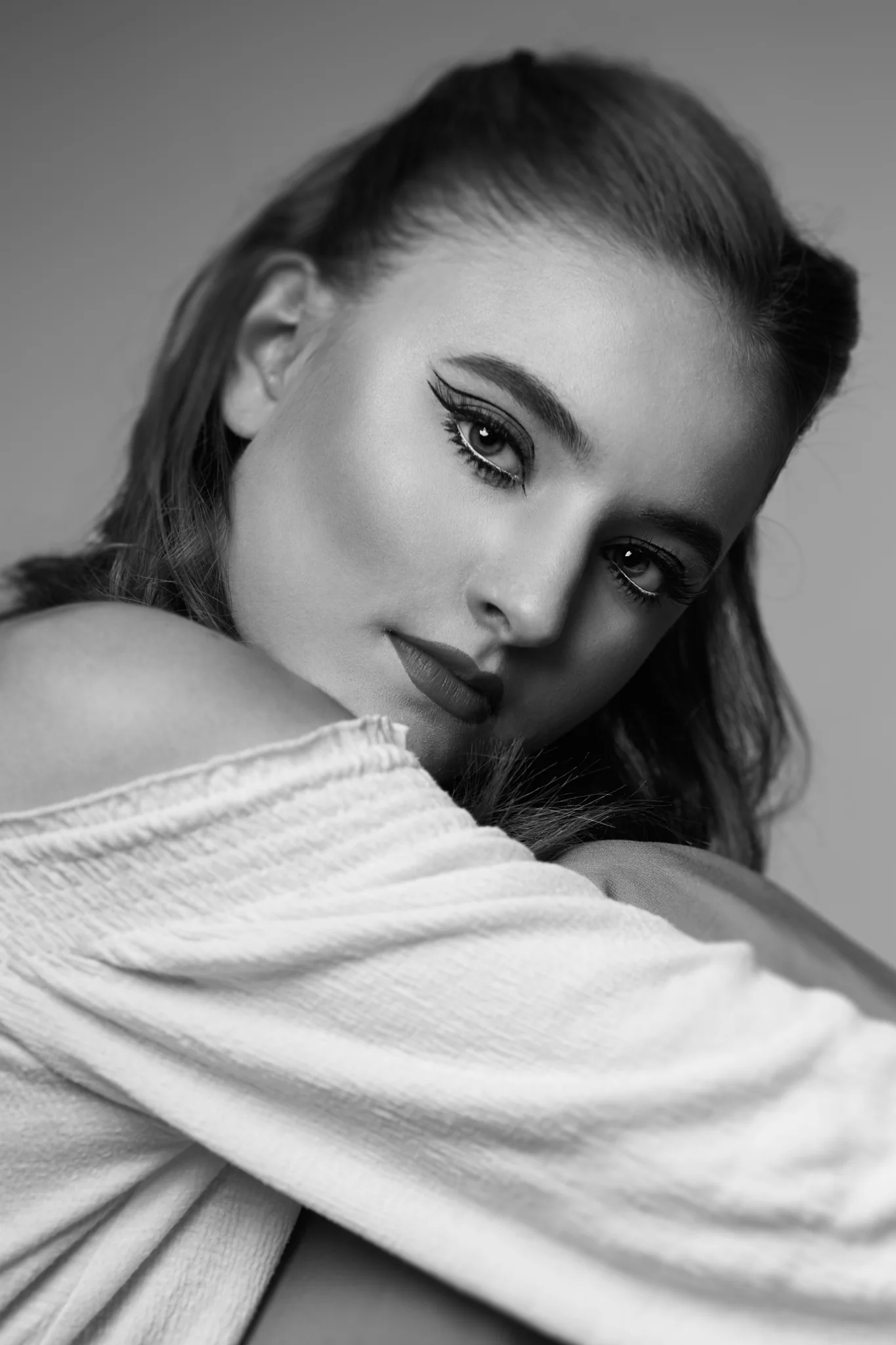 Makeup for a photo shoot with natural skin and styled hair.