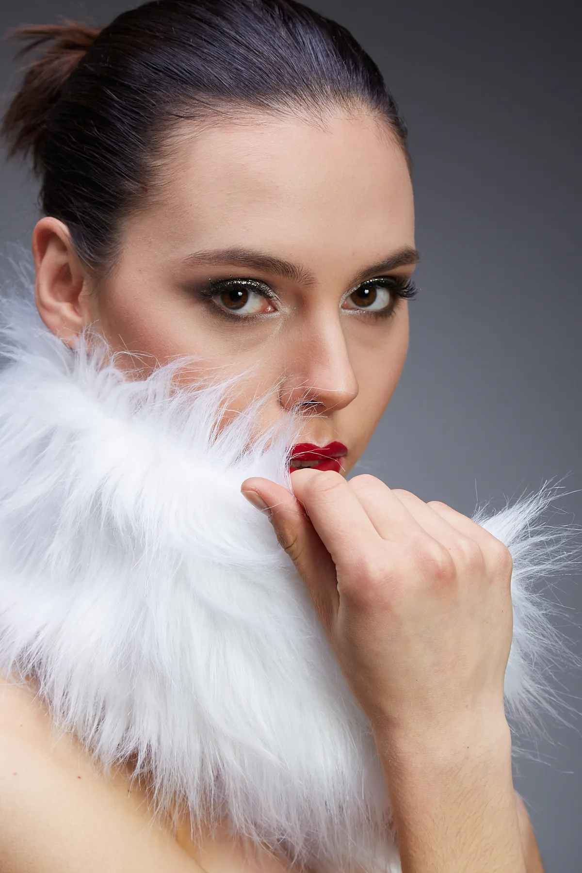 Wedding make-up with smoky eye shadow and smoothly styled hair.